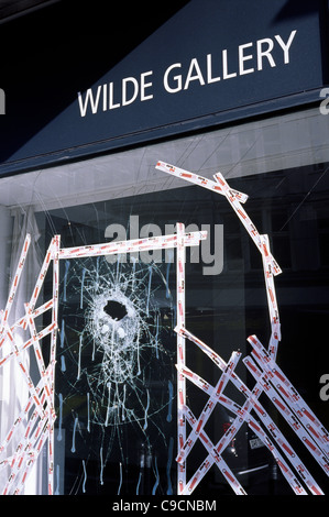 Shattered store front window pane taped together in a street of Berlin. Stock Photo