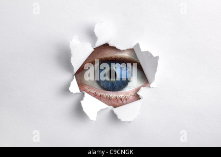 Looking through a hole in white paper Stock Photo