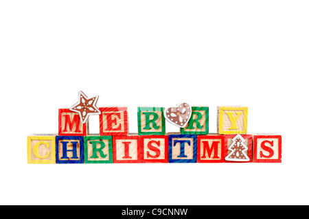 Merry Christmas in colorful children's block letters isolated on white background. Stock Photo