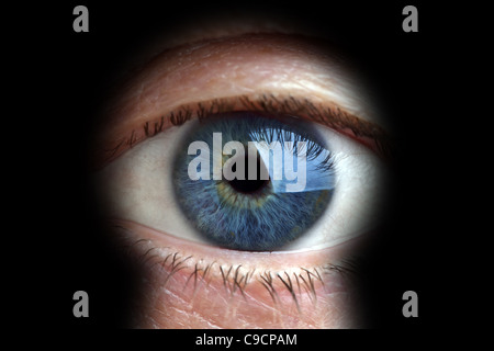 Man looking through keyhole Stock Photo