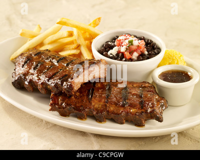 Baby back rib dinner with black beans and french fries Stock Photo