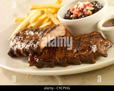 Baby back rib dinner with black beans and french fries Stock Photo