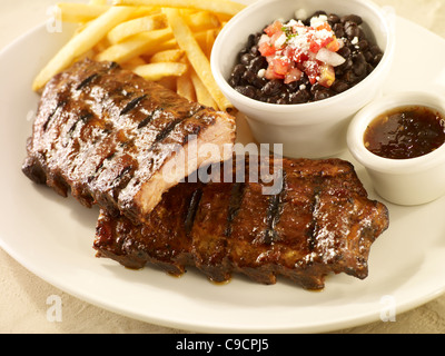 Baby back rib dinner with black beans and french fries Stock Photo