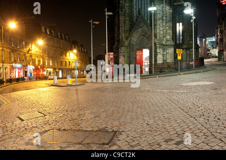 Edinburgh street scene at night looking towards Johnston Terrace and the Hub Café and Restaurant from The Royal Mile. Stock Photo