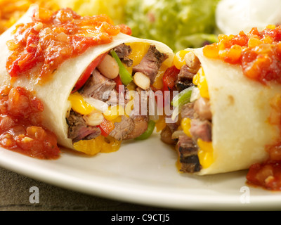 Steak fajita burrito smothered in red sauce Stock Photo
