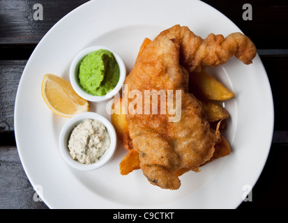 Fish and chips served with mushy peas and tartare sauce Stock Photo