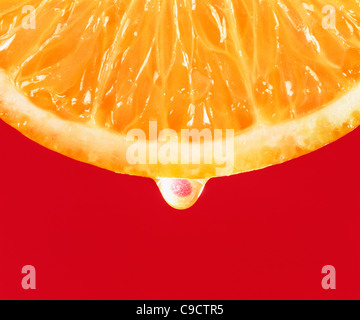 Close-up of orange slice showing pulp, segments and juice. Stock Photo