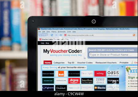 The My Voucher Codes website shot against a bookcase background (Editorial use only: ­print, TV, e-book and editorial website). Stock Photo