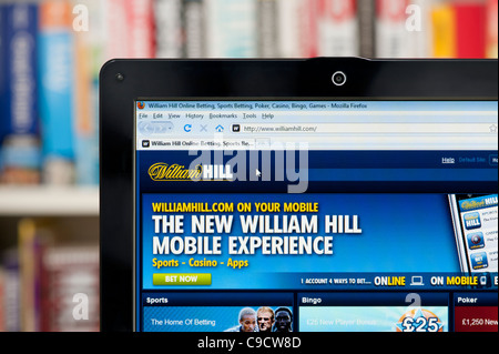 The William Hill website shot against a bookcase background (Editorial use only: print, TV, e-book and editorial website). Stock Photo