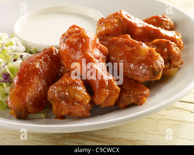 Spicy chicken wings served with ranch dressing on a white plate Stock Photo