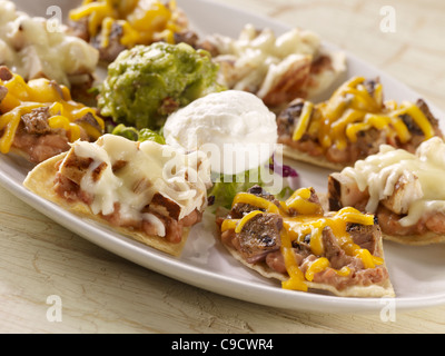 Fajita nachos combo topped with sour cream and guacamole Stock Photo