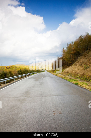 Speedway road and cloudy sky Stock Photo - Alamy