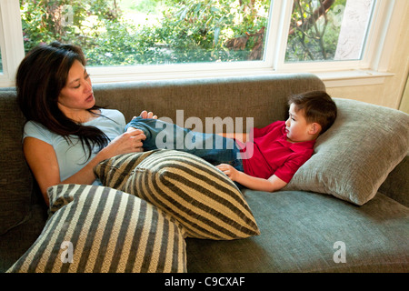 Mother and son talking on the couch. Stock Photo