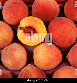 Ruston Red Peaches, whole and half showing stone, Georgia. Stock Photo