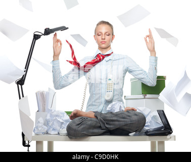 Calm business woman despite huge disorder on table and flying papers Stock Photo