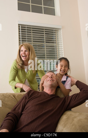 Portrait of a family playing in living room Stock Photo