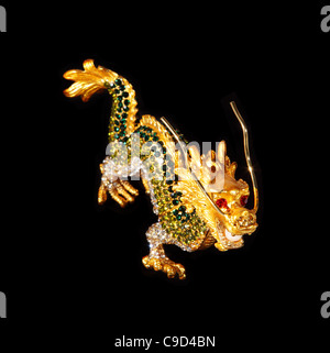 Metal dragon with crystals on the black background (souvenir) Stock Photo