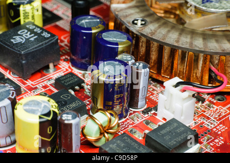 Electronic circuit board with capacitors, integrated circuits and other components. Stock Photo