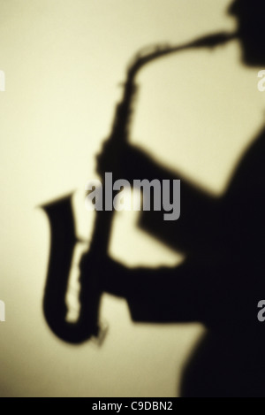 Silhouette of a man playing the saxophone Stock Photo