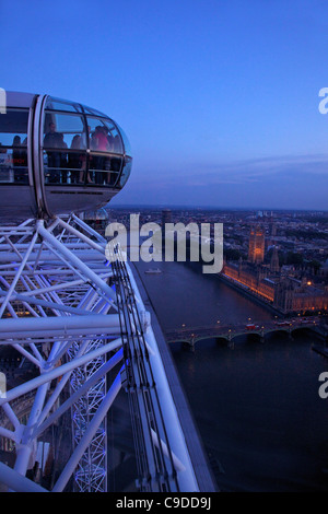 View of passenger pod capsule, Houses of Parliament, Big Ben and the River Thames from the London Eye at dusk,  London,  England