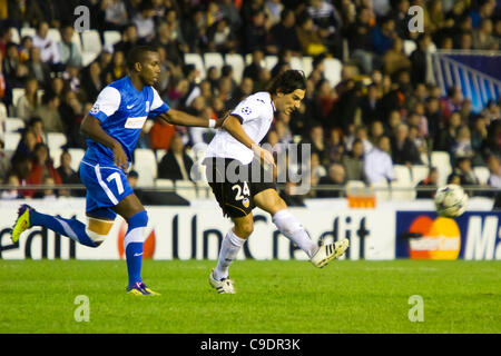 23/11/2011. Valencia, Spain  Football match between Valencia Club de Futbol and KRC Genk, Matchday 5, E Group, Champions League -------------------------------------  Tino Costa midfield player from VAlencia CF as he passes the ball with some oposition from Khaleem Hyland from KRC Genk Stock Photo