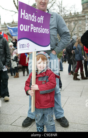 Belfast, UK. 30th Nov, 2011, Young boy (Eoin Burms) holds placard at public workers one-day strike. An estimated two million public sector union members took part in a UK-wide strike against Government pension plan reforms. Stock Photo