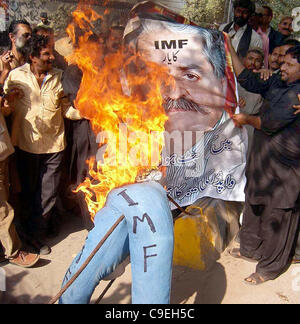 Members of WAPDA Hydro Electric Central Labor  Union burn an effigy as they are protesting against IMF and privatization of power companies Stock Photo