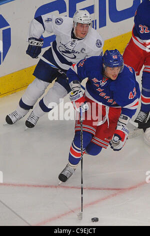 Dec. 08, 2011 - New York, New York, U.S - New York Rangers center Artem Anisimov (42) skates with the puck behind the net away from Tampa Bay Lightning center Vincent Lecavalier (4) during second period NHL action between the Tampa Bay Lightning and the New York Rangers at Madison Square Garden. (Cr Stock Photo