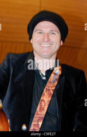 Belfast, 14/12/2011: Ciaran Gribbin, lead singer with the Austrialian band INXS, sings on the Alan Simpson radio show from Victoria Square Stock Photo