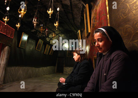 Dec. 16, 2011 - Bethlehem, West Bank, Palestinian Territory - A nun prays at the Grotto of the Church of the Nativity, the traditional birthplace of Jesus Christ, in the West Bank city of Bethlehem December 15, 2011, ahead of Christmas. Christian worshippers began their spiritual preparations ahead  Stock Photo