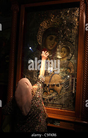 Dec. 16, 2011 - Bethlehem, West Bank, Palestinian Territory - A Christian worshipper prays in the Church of the Nativity, the site revered as the birthplace of Jesus, in the West Bank town of Bethlehem December 15, 2011, ahead of Christmas. Christian worshippers began their spiritual preparations ah Stock Photo