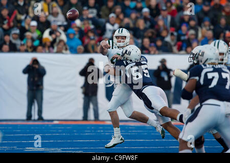 Dec. 17, 2011 - Boise, Idaho, United States of America - 17 December 2011: Ohio quarterback Tyler Tettleton (4) passing under pressure from Ohio State's Bojay Filimoeatu (55) during first half action of the Famous Idaho Potato Bowl in Boise Idaho. The Utah State Aggies led the Ohio Bobcats 9-7 at th Stock Photo