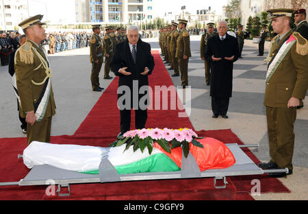 Dec. 24, 2011 - Ramallah, West Bank, Palestinian Territory - Palestinian President, Mahmoud Abbas (Abu Mazen), lays a wreath of flowers on the body of the late fighter Mustafa al-Maliki former governor of Qalqilya presidential headquarters in  the west bank city of Ramallah, on Dec. 24, 2011. Photo  Stock Photo