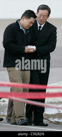 December 09, 2008. San Diego,  CA. - DONG YUN YOON (LEFT) arrived at the site of Monday's Marine Corps F/A-18D crash with his minister THE REV. DANIEL SHIN (right) as well as friends and representatives from the San Diego Police Department (not shown). Husband and father DONG YUN YOON was visiting t Stock Photo