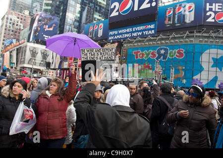 Street preacher wades into the crowd in New York City's Times Square on New Year's Eve 2011. More than one million people from around the world will eventually join the celebration in the Big Apple. Stock Photo