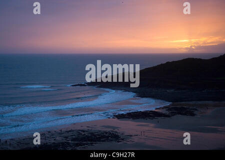 The sun sets on New Years day 2012 at Langland Bay on the Gower Peninsula near Swansea in South Wales, UK on 1st January 2012. Stock Photo