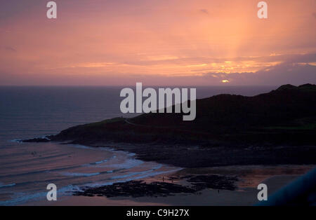 The sun sets on New Years day 2012 at Langland Bay on the Gower Peninsula near Swansea in South Wales, UK on 1st January 2012. Stock Photo