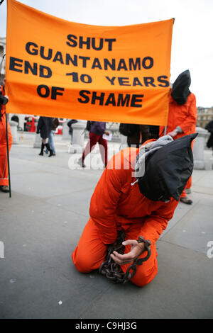 People wearing orange clothes protest in occasion of the 10th anniversary of Guntanamo Bay in Trafalgar Square, London on 07/01/ Stock Photo
