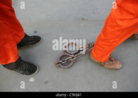 People wearing orange clothes protest in occasion of the 10th anniversary of Guntanamo Bay in Trafalgar Square, London on 07/01/ Stock Photo