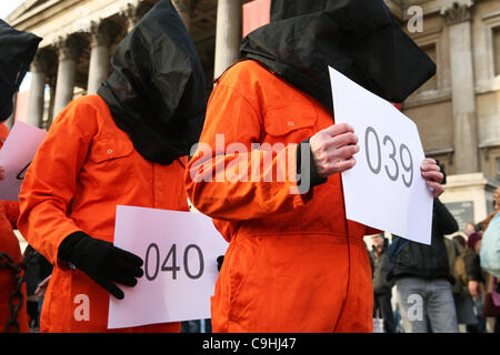 People wearing orange clothes protest in occasion of the 10th anniversary of Guntanamo Bay in Trafalgar Square, London on 07/01/2012. Stock Photo