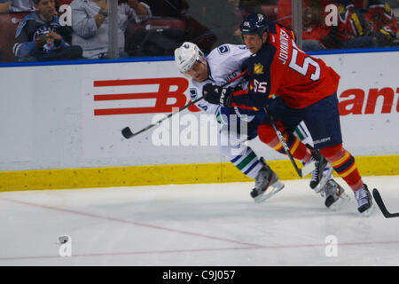 Jan. 9, 2012 - Sunrise, Florida, United States of America - Florida Panthers defenseman Ed Jovanovski (55) fights for the puck while Vancouver Canucks center Cody Hodgson (9) defends during the game between the Vancouver Canucks and Florida Panthers at the Bank Atlantic Center in Sunrise, FL. (Credi Stock Photo