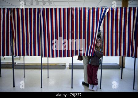 Jan. 10, 2012 - Penacook, New Hampshire, U.S - Ashley Constant, 5, Penacook, peeks out of the voting booth while her mother Denise Constant votes. Local citizens vote at the Immaculate Conception Parish polling place in Ward 1, near Concord, in the Village of Penacook, NH. on the day of the New Hamp Stock Photo