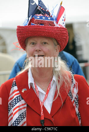 Jan 16, 2012 - Myrtle Beach, South Carolina; USA -A GOP Supporter stands outside of Mount Myrtle. A sand sculpture of the GOP Candidates outside of the FOX Debate that took place at the Myrtle Beach Convention Center.  The sand sculpture depicts Rick Santorum, Newt Gingrich, Jon Huntsman, Mitt Romne Stock Photo