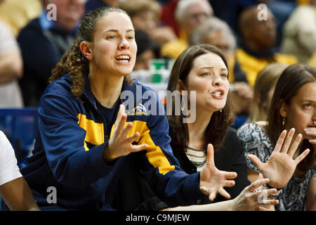 Jan. 25, 2012 - Toledo, Ohio, U.S - Injured Toledo guard Naama Shafir (left) and assistant coach Katie Griggs (right) shout instructions to the players on the court during second-half game action.  The Toledo Rockets, of the Mid-American Conference West Division, defeated the Miami RedHawks, of the  Stock Photo