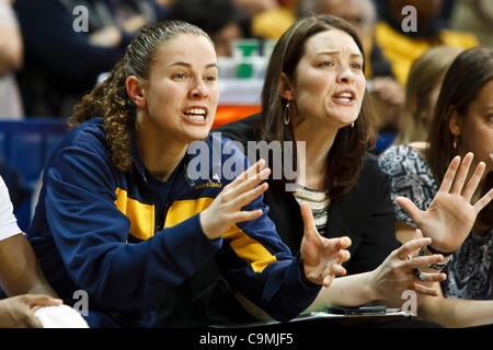 Jan. 25, 2012 - Toledo, Ohio, U.S - Injured Toledo guard Naama Shafir (left) and assistant coach Katie Griggs (right) shout instructions to the players on the court during second-half game action.  The Toledo Rockets, of the Mid-American Conference West Division, defeated the Miami RedHawks, of the  Stock Photo