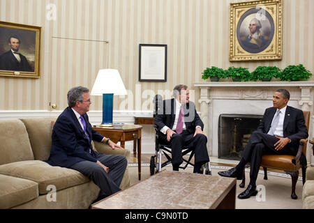 President Barack Obama meets with former President George H.W. Bush and son former Florida Governor Jeb Bush in the Oval Office January 27, 2012 in Washington, DC. The former president was in Washington and stopped in as a social call. Stock Photo