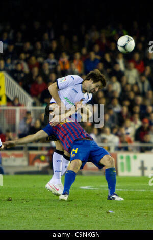 01/02/2011 - VALENCIA, Spain // COPA DEL REY FOOTBALL - Soccer - Valencia CF vs. FC Barcelona - 1/2 finals - Estadio Mestalla --------- Albelda from Valencia CF and Mascherano from FC Barcelona as they duel for a ball Stock Photo