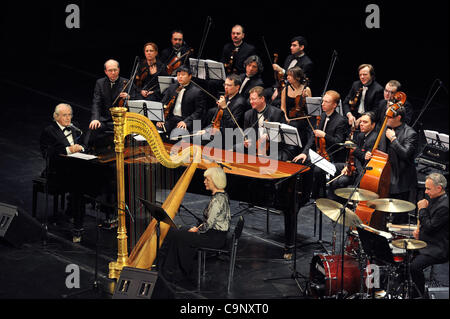 February 01,2012.St.Petersburg,Russia. Legendary French composer Michel Legrand Michel Legrand performing a special concert in St.Petersburg to celebrate the momentous occasion of his 80th birthday.  Pictured: Michel Legrand (l)and his wife harpist Catherine Michel (c)during the concert. Stock Photo