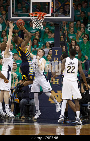 Notre Dame guard Pat Connaughton, left, drives the lane as Virginia ...