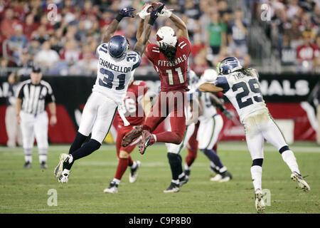 Jan. 1, 2012 - Glendale, Arizona, U.S - Arizona Cardinals wide receiver Larry Fitzgerald (11) jumps and makes a catch in double coverage during a NFL game against the Seattle Seahawks at University of Phoenix Stadium in Chandler, AZ. (Credit Image: © Gene Lower/Southcreek/ZUMAPRESS.com) Stock Photo